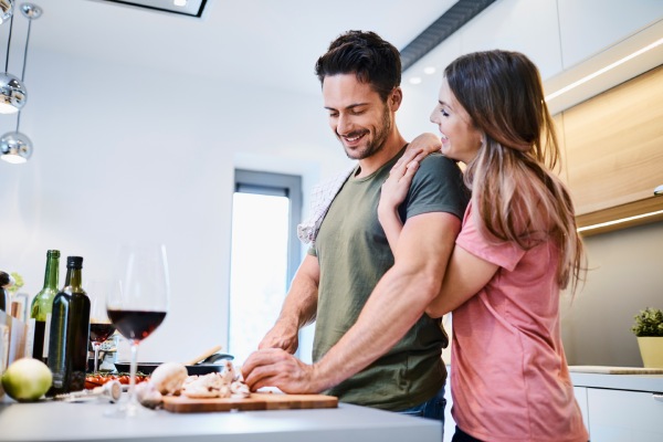 man and woman cooking together