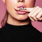 woman shows a sign of silence