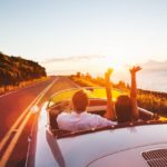 Couple Driving on Country Road into the Sunset